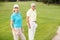 Portrait of confident golfer couple