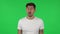 Portrait of confident guy is frustrated saying oh my god. Green screen