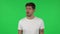 Portrait of confident guy is frustrated saying oh my god. Green screen