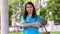 Portrait of a confident, happy, and smiling Asian medical woman doctor or nurse wearing blue scrubs uniform