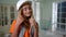 Portrait of confident happy teenage girl in white hard hat looking around smiling. Positive pretty cute Caucasian