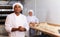 Portrait of confident latino chef in bakery