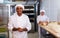 Portrait of confident latino chef in bakery