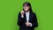 Portrait of confident mature business woman in black suit on green background