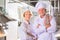 Portrait of confident mature chefs standing with cross arms at kitchen restaurant