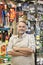 Portrait of a confident mature store clerk with arms crossed in hardware shop