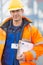 Portrait of confident mid adult man with clipboard in shipping yard