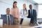 Portrait of confident multi-ethnic business people at desk in office