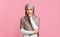 Portrait of confident muslim girl in hijab over pink background