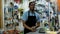 Portrait of confident owner of household goods store standing behind counter