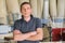 Portrait of confident owner of industrial small business carpenters workshop, man with crossed arms