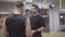 Portrait of confident personal trainer explaining workout program to young Caucasian man. Two positive sportive men