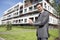 Portrait of confident real estate agent showing office building