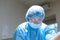 Portrait confident serious female surgeon in surgical room hospital, medical doctor wear surgery suit and protective glasses