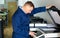 Portrait of confident service engineer standing by photocopy machine in office