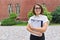 Portrait of confident smiling businesswoman, female teacher, counselor with clipboard paper documents