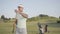Portrait confident successful middle eastern man with a golf club standing on a golf course in good sunny weather. Sport