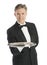 Portrait Of Confident Waiter In Tuxedo Carrying Serving Tray