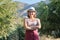 Portrait of confident woman olive farm owner, background olive trees in the mountains