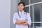 Portrait of confident young female medic with stethoscope with crossed arms