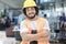 Portrait of confident young manual worker holding walkie-talkie in metal industry