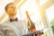 Portrait of confident young waiter serving wine at restaurant