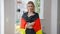 Portrait of confident young woman wrapping in German flag looking at camera smiling. Happy relaxed Caucasian lady posing