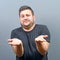 Portrait of a confused man against gray background