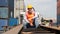 Portrait of containers yard and cargo inspector on container truck working outdoors with background of stacked containers