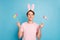 Portrait of content imposing guy ready celebrate easter holidays hold green yellow pink purple painted eggs wear fluffy