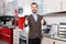 Portrait of contented bearded guy in kitchen furnishing store