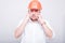 Portrait of contractor wearing hardhat covering his ears