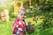 Portrait of cool baby boy  harvesting rural apples