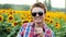 Portrait of cool male-farmer dancing fun on sunflowers field, pleased and positive on sunset. Farming concept