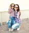 Portrait cool mother and child wearing a checkered shirts and sunglasses