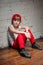 Portrait of cool young hip hop boy in red hat and red pants