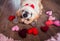 portrait of a corgi dog puppy lies on the wooden floor among the scarlet and pink hearts