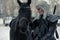 Portrait of cosplayer in image of a character Geralt of Rivia from the game or film The Witcher next to a horse in forest