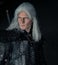 Portrait of cosplayer in image of character Geralt of Rivia from the game or film The Witcher with sword behind his back