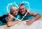 Portrait of couple with arm around in swimming pool