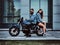 Portrait of couple in denim jackets with motorbike