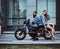 Portrait of couple in denim jackets with motorbike
