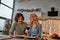 Portrait of a couple having a glass of red wine while cooking Christmas supper. Front view