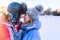 Portrait of couple in love in winter in snowfall at sunset or dawn