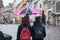 Portrait of couple with pink umbrella on cobbles place in the city