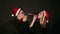 Portrait of a couple in Santa hats, they blow in pipe the whistle on a new year.