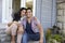 Portrait Of Couple Sitting On Steps Outside Home