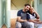 Portrait Of Couple Taking A Break From Building Outdoor Summerhouse In Garden