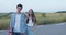 Portrait of couple of teenagers with skateboard smiling at camera on nature