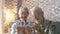 Portrait of couple of two old pensioners holding together numbers of 2023 at home. Close up of new year numbers, celebrating and